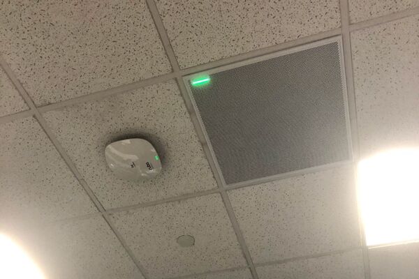 White 2¿ x 2¿ tile mounted in the ceiling to provide microphone coverage over student seating