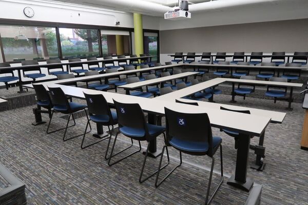 Back of room view of student fixed-table and chair seating 