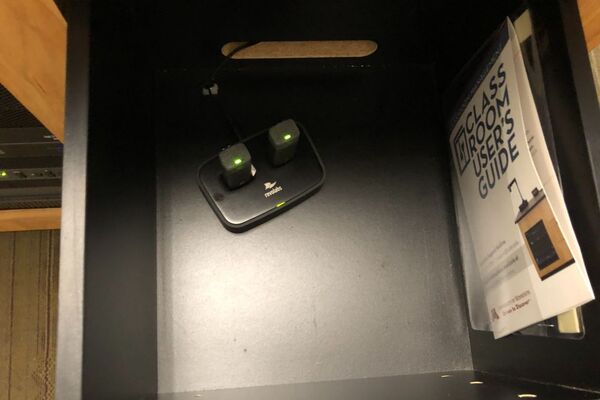 Pedestal - inside view of drawer showing two wireless mics in charging base