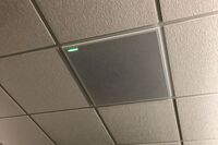 White 2¿ x 2¿ tile mounted in the ceiling to provide microphone coverage over student seating