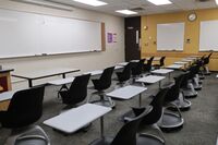 Front of room view with lectern on left in front of markerboard 