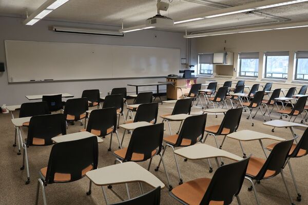 Front of room view with lectern on right in front of markerboard