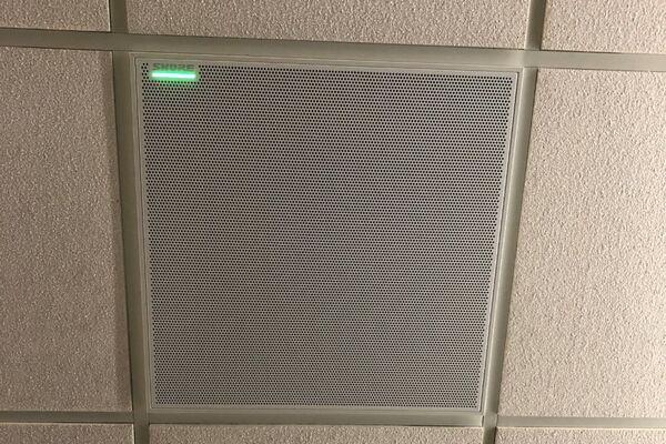 White 2¿ x 2¿ tile mounted in the ceiling to provide microphone coverage over student seating