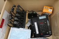 Pedestal - inside view of drawer showing two wireless mics in charging base, telephone, and assistive listening devices in charger