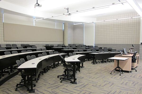 Back of room view of student tiered fixed-table and chair seating 