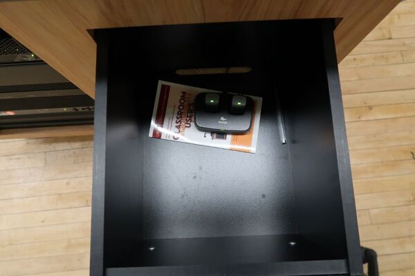 Pedestal - inside view of drawer showing two wireless mics in charging base