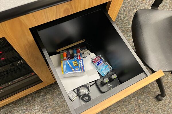 Pedestal - inside view of drawer showing two wireless mics in charging base