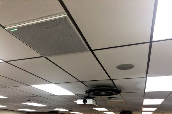 White 2¿ x 2¿ tile mounted in the ceiling to provide microphone coverage over student seating