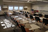 Front of room view with lectern on left in front of markerboard 