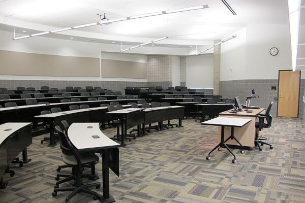 Back of room view of student tiered fixed-table and chair seating 