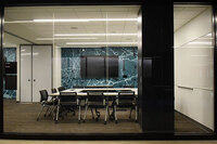 Photo looking through glass wall into classroom.