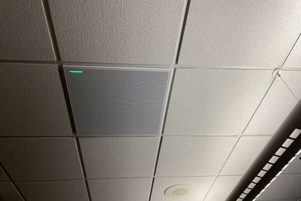 White 2¿ x 2¿ tile mounted in the ceiling to provide microphone coverage over student seating