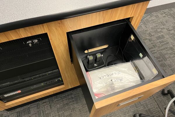 Pedestal - inside view of drawer showing two wireless mics in charging base