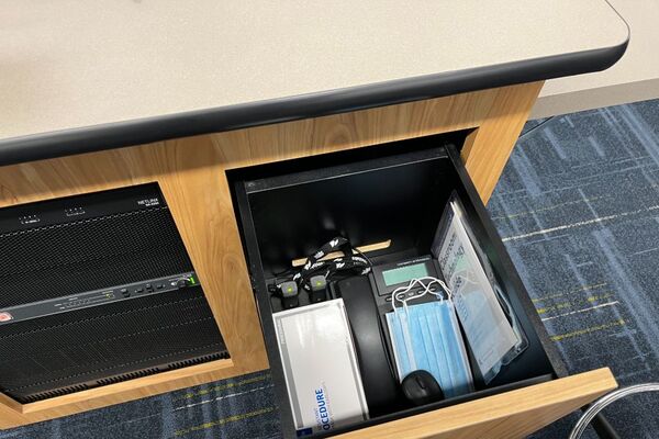 Pedestal - inside view of drawer showing two wireless mics in charging base