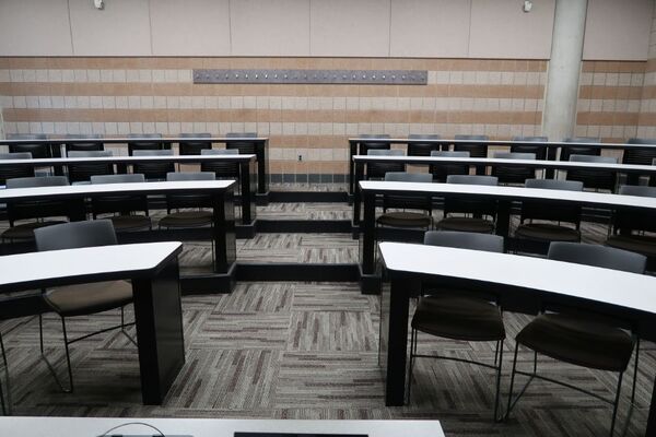 Back of room view of student tiered fixed-table and chair seating 