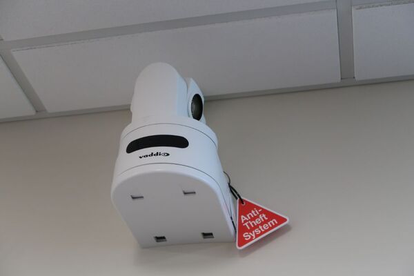 Camera mounted to a wall and instructor enabled adjustments to the lens to allow the instructor to be "seen" by the camera in more locations around the room