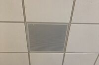 White 2¿ x 2¿ tile mounted in the ceiling to provide microphone coverage over student seating