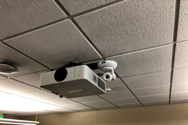 Camera mounted to ceiling and instructor enabled adjustments to the lens to allow the instructor to be "seen" by the camera in more locations around the room