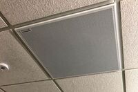 White 2¿ x 2¿ tile mounted in the ceiling to provide microphone coverage over student seating