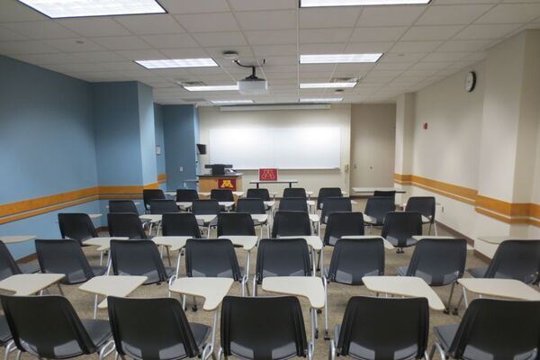 Front of room view with lectern on left in front of markerboard 