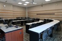 Back of room view of student tiered fixed-table and chair seating 