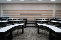 Back of room view of student tiered fixed-table and chair seating 