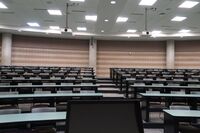 Back of room view of student tiered fixed-table and chair seating