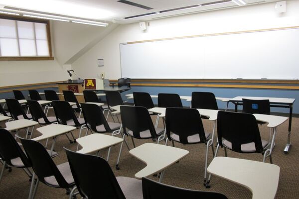 Front of room view with lectern on left in front of markerboard 