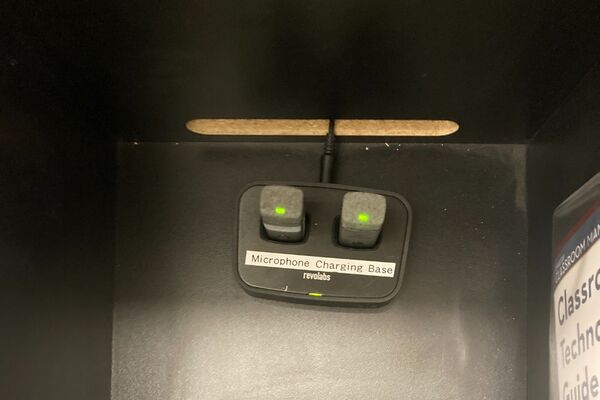 Pedestal - inside view of drawer showing two wireless mics in charging base