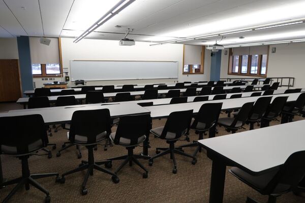 Front of room view with lectern on left in front of markerboard