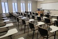 Front of room view with lectern on left in front of markerboard