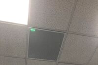 White 2¿ x 2¿ tile mounted in the ceiling to provide microphone coverage over student seating