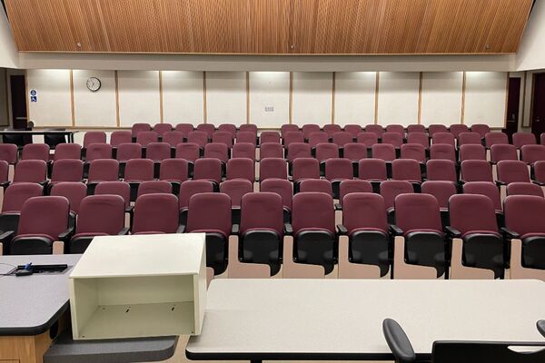 Back of room view of student auditorium seating with exit doors at rear of room