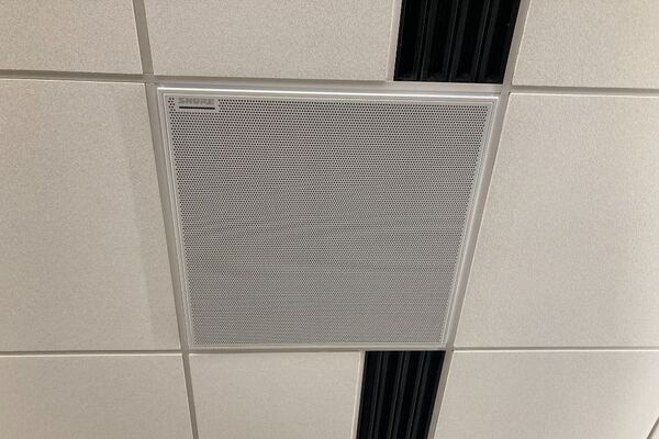 White 2¿ x 2¿ tile mounted in the ceiling to provide microphone coverage over student seating