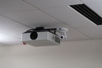 Camera mounted to ceiling and instructor enabled adjustments to the lens to allow the instructor to be "seen" by the camera in more locations around the room