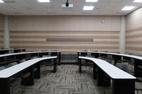 Back of room view of student tiered fixed-table and chair seating 