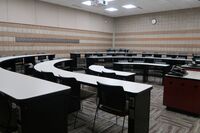 Back of room view of student tiered fixed-table and chair seating 