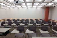 Rear of room view of student tablet arm chair seating on casters