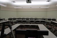 Back of room view of student tiered fixed table and chair seating