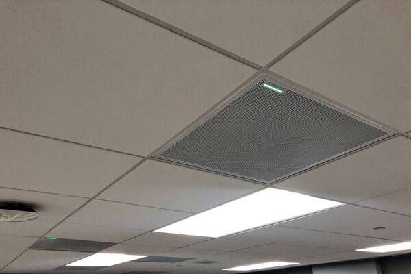 White 2¿ x 2¿ tile mounted in the ceiling to provide microphone coverage over student seating