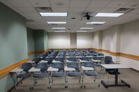 Back of room view of student tablet arm seating and double exit doors at rear of room