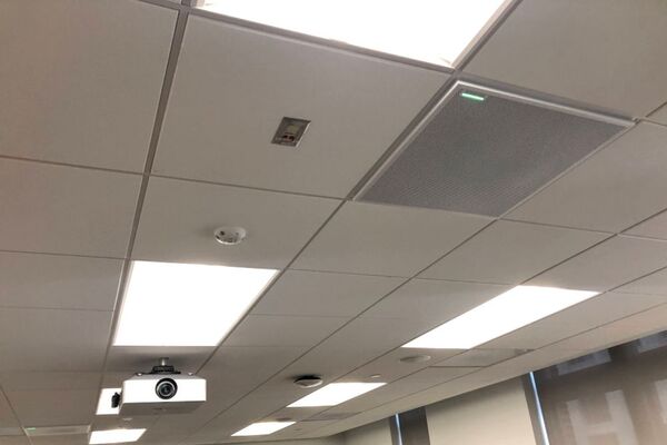 White 2¿ x 2¿ tile mounted in the ceiling to provide microphone coverage over student seating