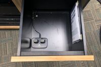 Pedestal - inside view of drawer showing two wireless mics in charging base