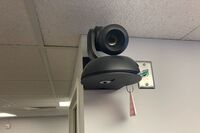 Camera mounted to a wall and instructor enabled adjustments to the lens to allow the instructor to be "seen" by the camera in more locations around the room