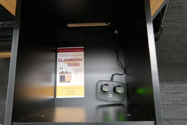 Pedestal - inside view of drawer showing two wireless mics in charging base