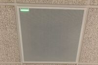 White 2¿ x 2¿ tile mounted in the ceiling to provide microphone coverage over student seating