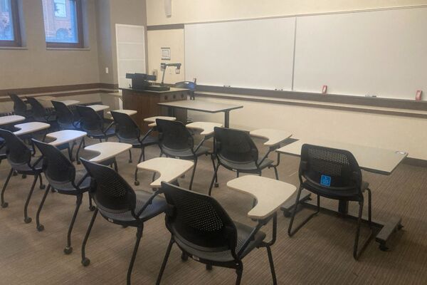 Front of room view with lectern on left in front of markerboard 