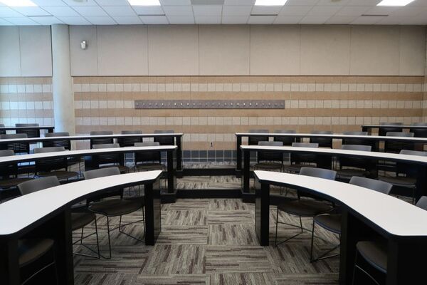 Back of room view of student tiered fixed-table and chair seating 