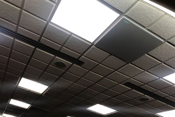 White 2¿ x 2¿ tile mounted in the ceiling to provide microphone coverage over student seating