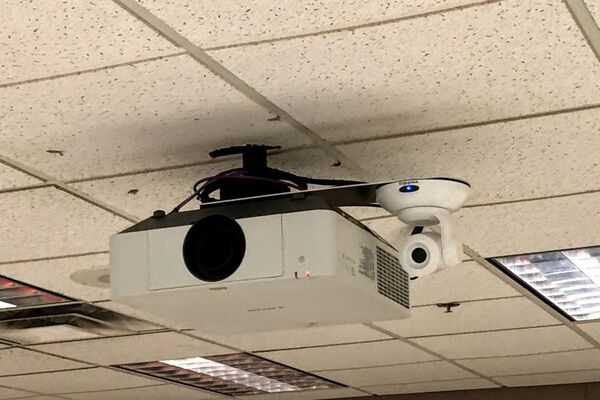 Camera mounted to ceiling and instructor enabled adjustments to the lens to allow the instructor to be "seen" by the camera in more locations around the room